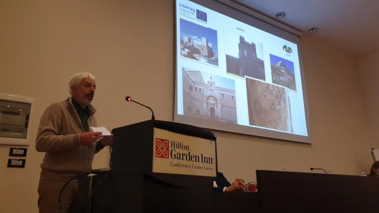 Un intervento dal leggio davanti alla platea della conferenza — PORTOLANES, Hotel Hilton Garden Inn, Lecce